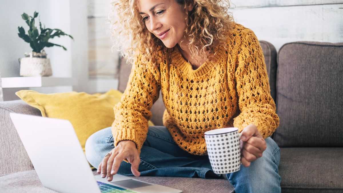 Young woman in casual clothing doing work from home with his laptop.