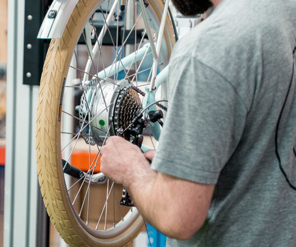 A person is checking the quality of a cycle that has been assembled for the package.